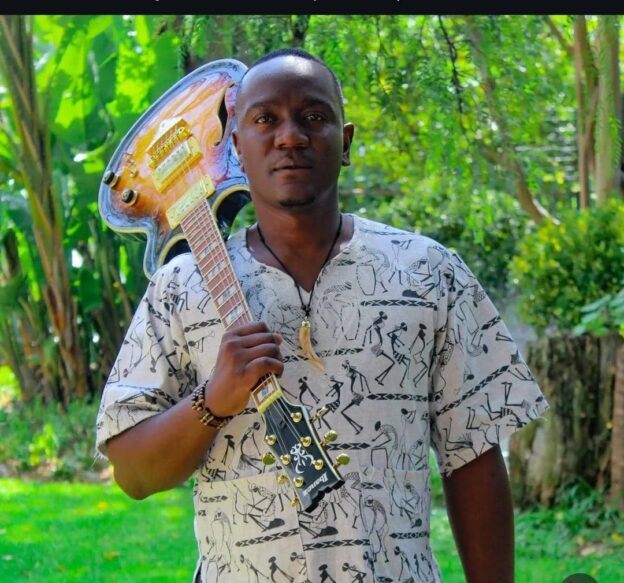 Zimbabwean artist playing guitar with mbira influence